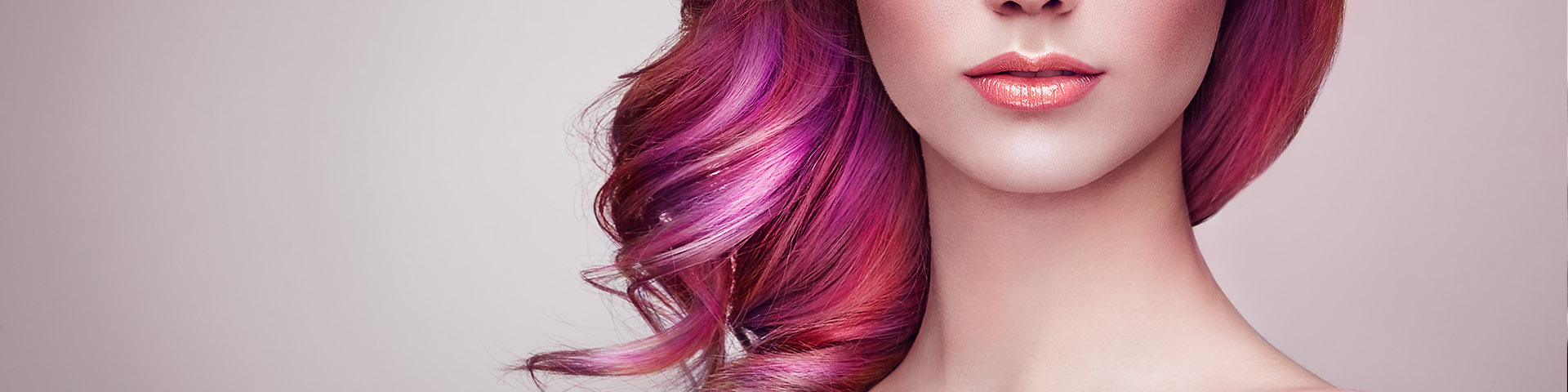 A woman with pink hair and purple highlights.