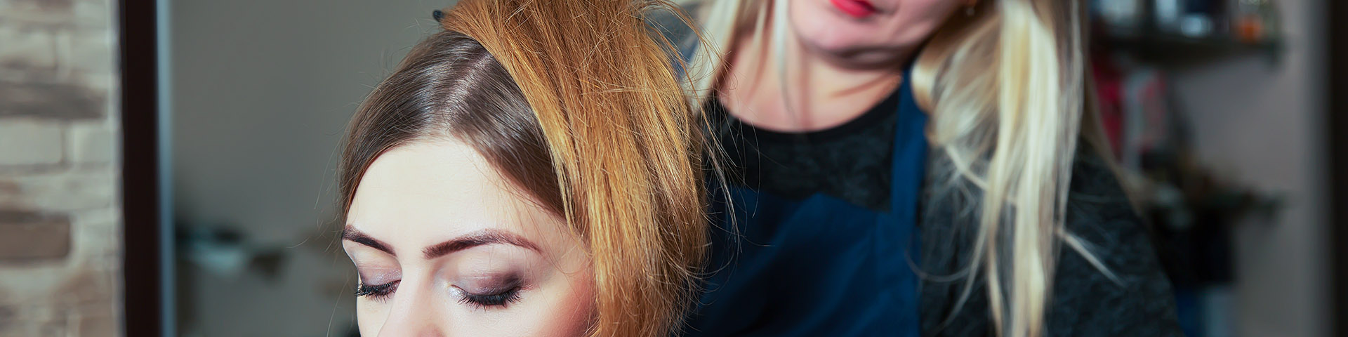 A close up of two women with long hair