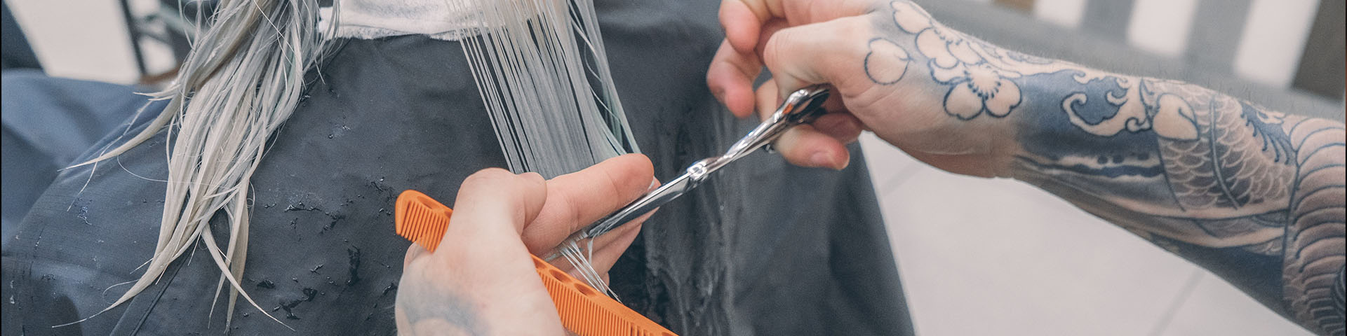 A person cutting something with scissors and comb.