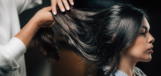 A person brushing their hair with a dog.