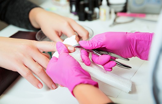 image1 A person is getting their nails done by someone else.
