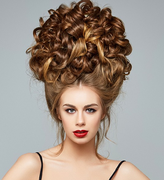 A woman with big hair in the middle of her head.