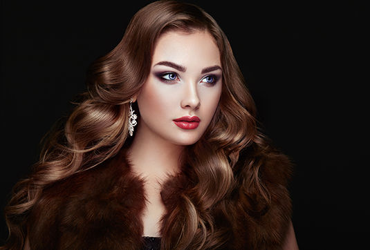 A woman with long hair and a fur coat.