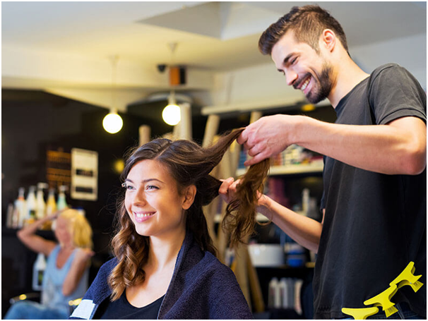 A man is cutting the hair of a woman.