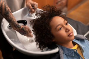 Professional hairstylist styling a client's hair at a modern hair salon in Westchester.